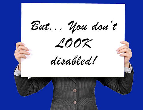 Person holding a sign saying 'but you don't look disabled'